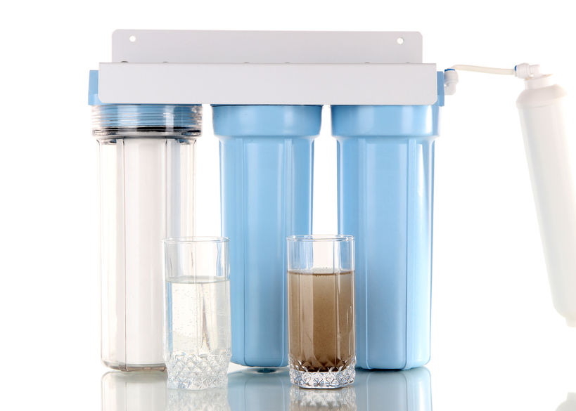 Three Stage Water Filters Lined Together With Glasses of Clean & Dirty Water to Represent the Process